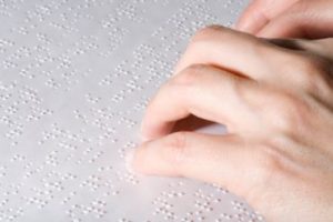 Female hands reading Braille
